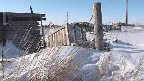 Garbage in abandoned ghost town of Gudym Chukotka of far north of Russia. Hopelessness in deserted city. photo