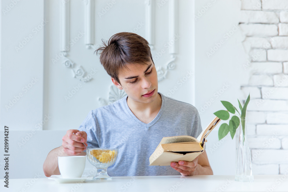 Young man drinking coffee and having breakfast Young man drinking coffee and having breakfast