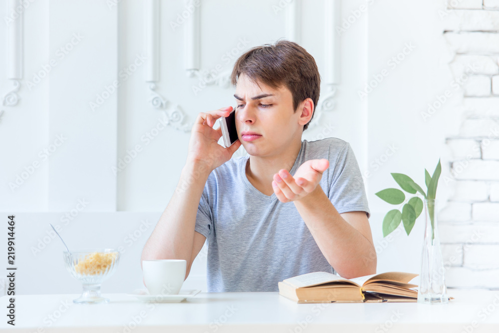 Young man drinking coffee and having breakfast Young man drinking coffee and having breakfast