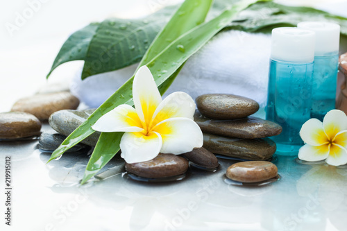 Oil tube for body. Body care and spa concept with flower and stones