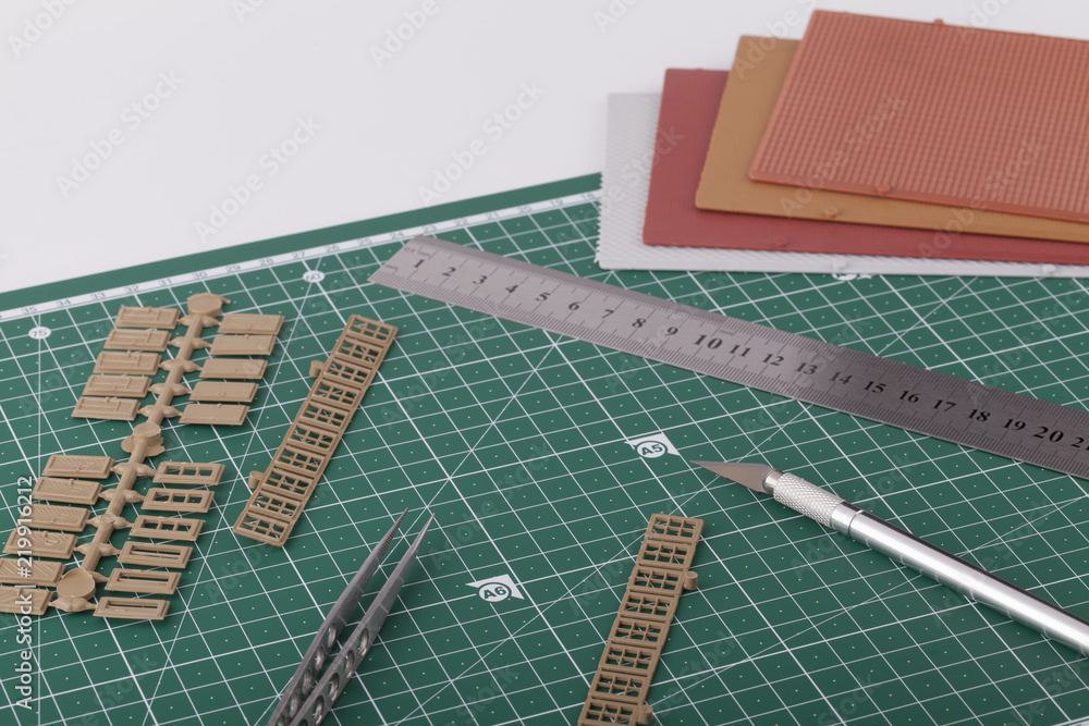 Creating train layout with tools on cutting mat