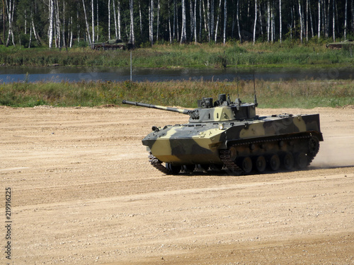 Russian tracked combat vehicle landing BMD-4M in motion on the river bank