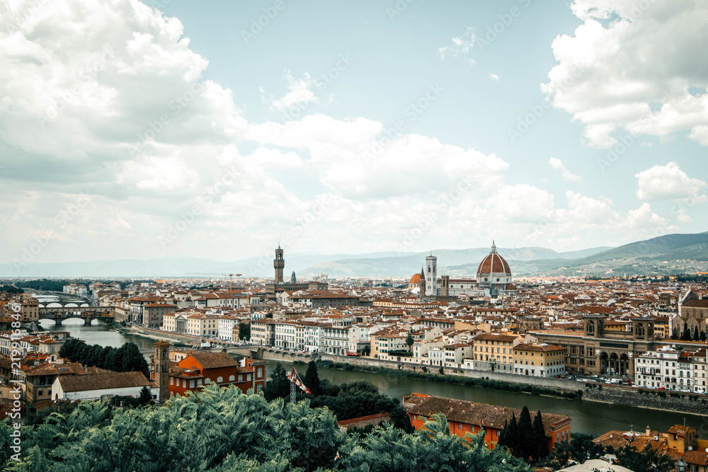 Panorama of Florence Firenze: Duomo, Arno River, towers, cathedrals, tiled roofs of houses from Piazzale Michelangelo, top view, Florence, Tuscany, Italy. Picture is tinted with vintage filter.
