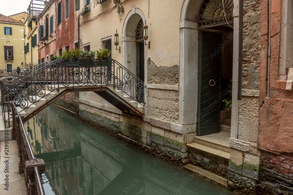 View of canal in Venice whis small bridge. Architecture and landmarks of Venice. Italy.