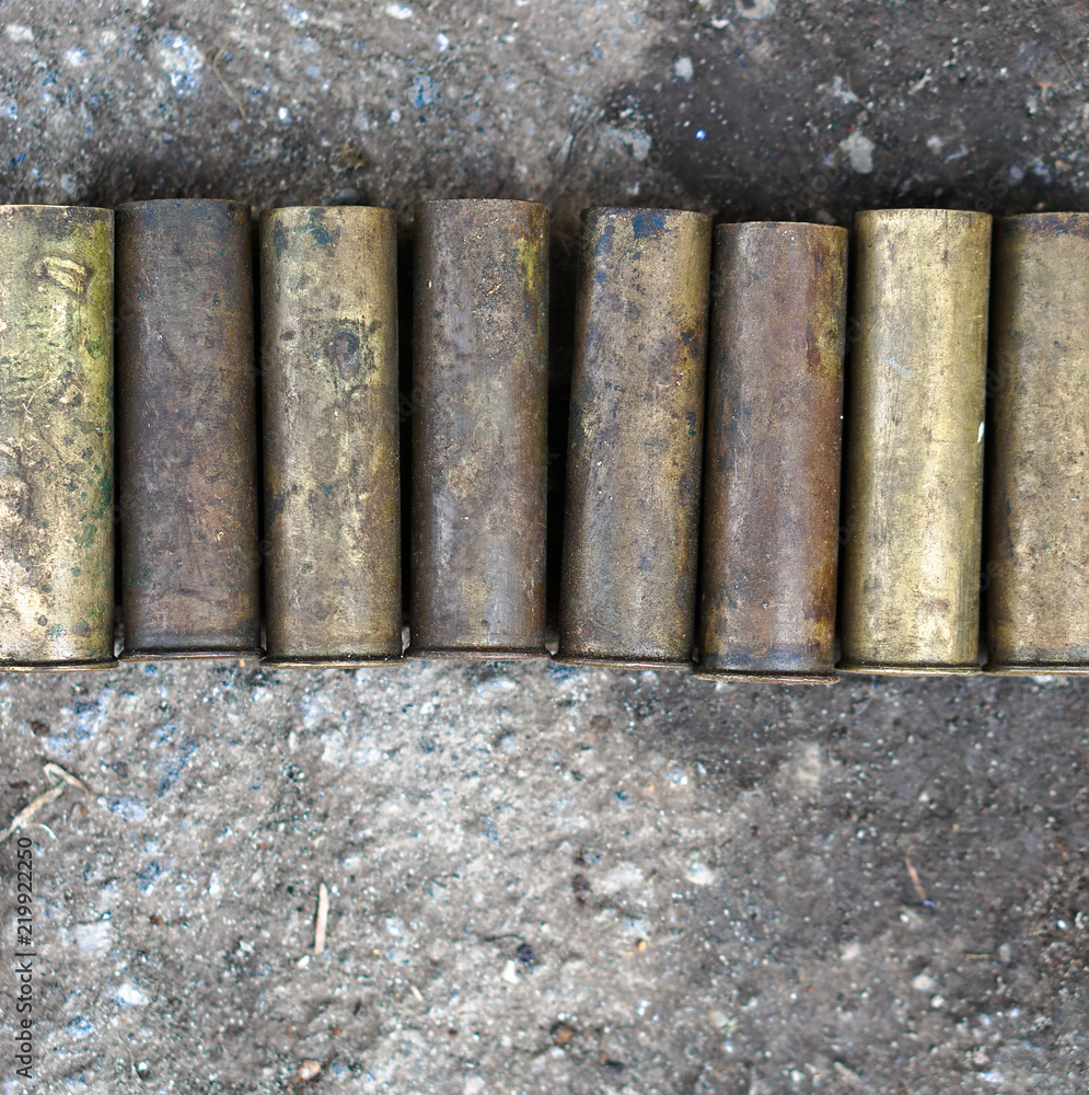 Sleeve from the gun on the background of a concrete structure. Military ...