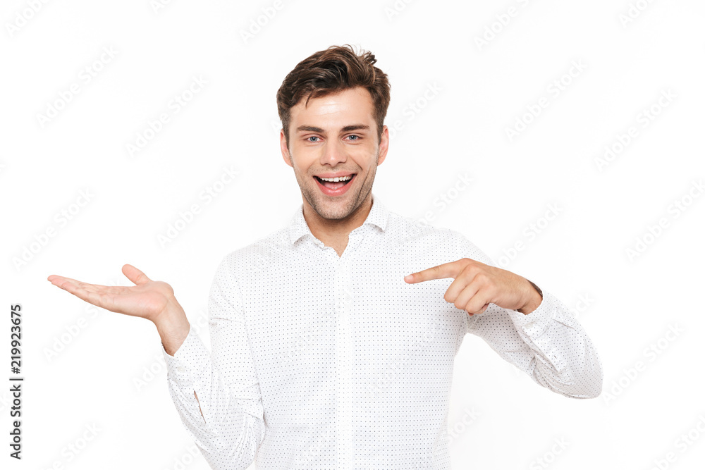 Photo of young man 30s holding and demonstrating copyspace on palm, isolated over white background Photo of young man 30s holding and demonstrating copyspace on palm, isolated over white background