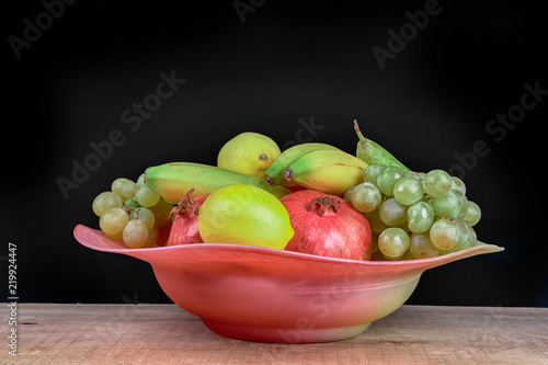 pomegranates and other fruits in a bowl
