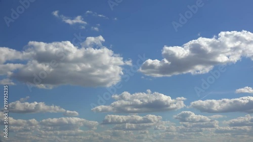 Floating white clouds on blue sky. Timelapse photo