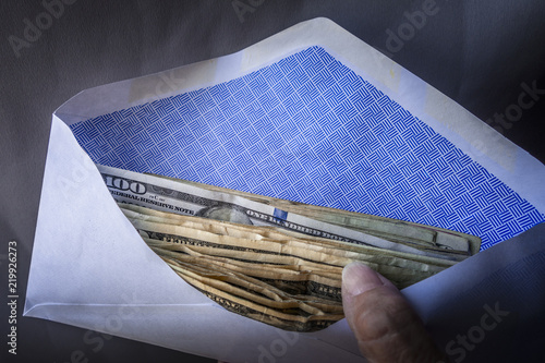 Wallpaper Mural Holding an envelope with cash , dollars Torontodigital.ca