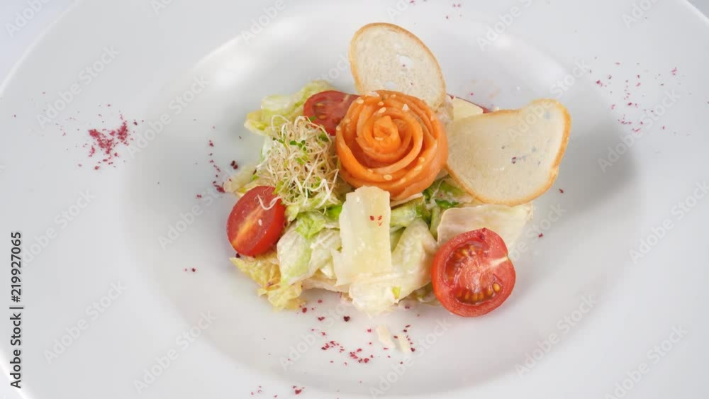 Salmon salad with tomatoes, crispy bread and parmesan cheese, served in Restaurant, loop Salmon salad with tomatoes, crispy bread and parmesan cheese, served in Restaurant, loop