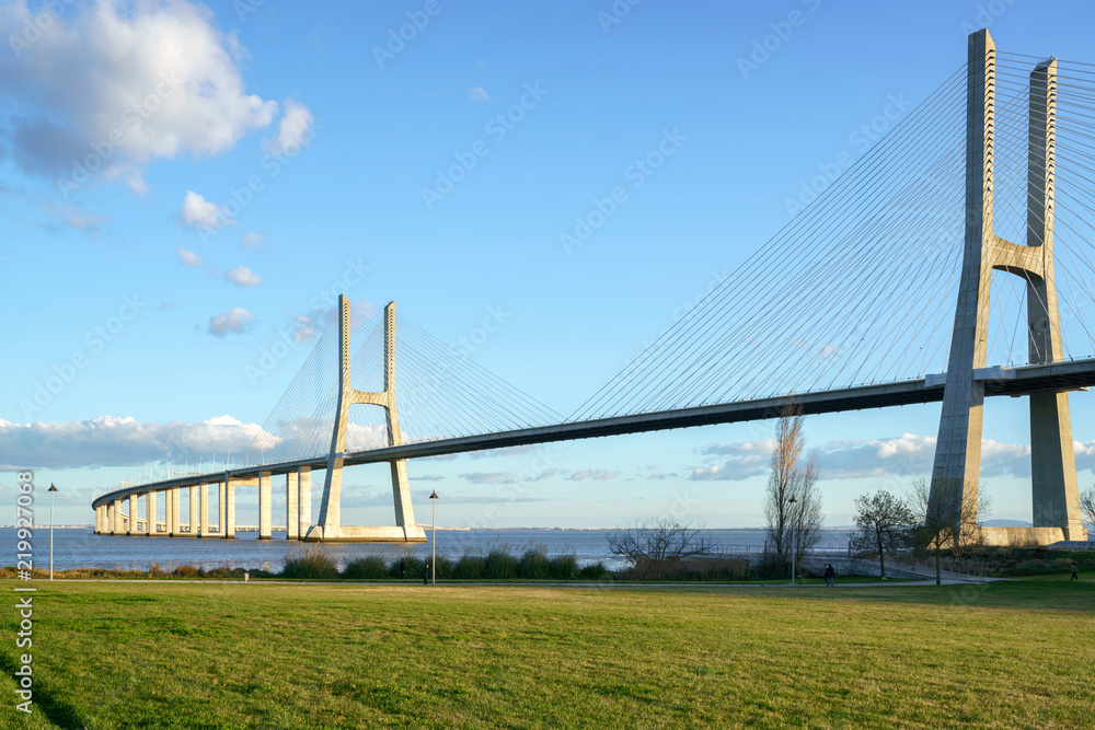 Ponte Vasco da Gama Bridge view from a garden park during the day Ponte Vasco da Gama Bridge view from a garden park during the day