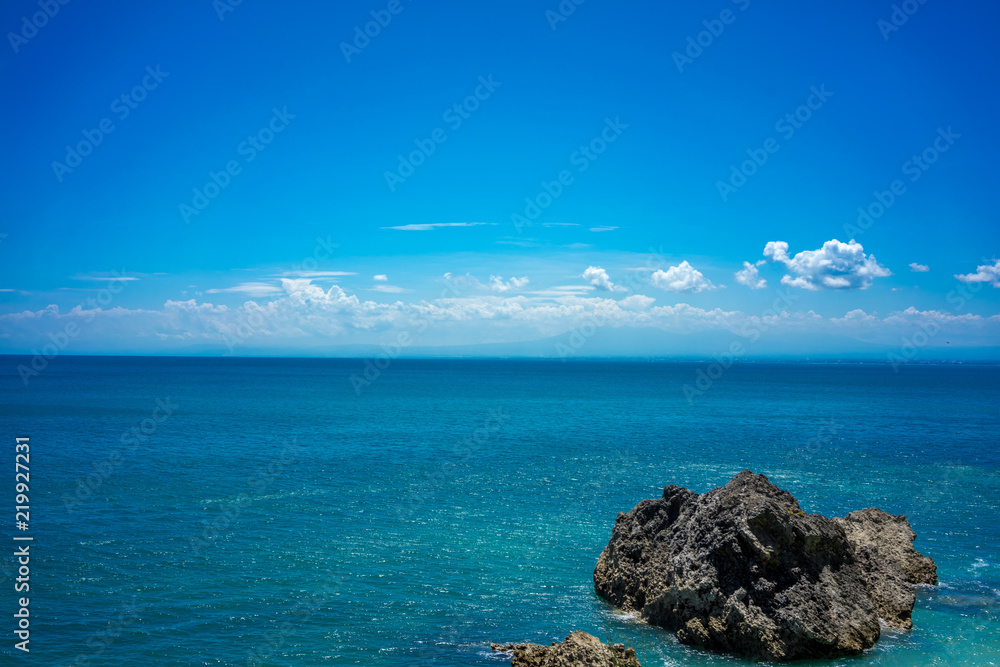 big stone rock blue ocean and sky