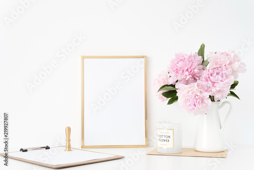 Modern gold portrait a4 frame mock up with a bouquet pink peonies in white jug, gold stamp. Overlay your quote, promotion, headline, or design, great for small businesses, lifestyle bloggers
