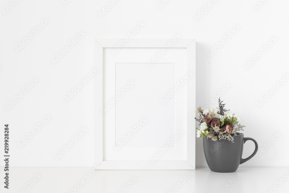 White A5 portrait frame mockup with cute bouquet of dried flowers pot on white wall background. Empty frame, poster mock up for presentation design. Template frame for text, lettering, modern art. White A5 portrait frame mockup with cute bouquet of dried flowers pot on white wall background. Empty frame, poster mock up for presentation design. Template frame for text, lettering, modern art.