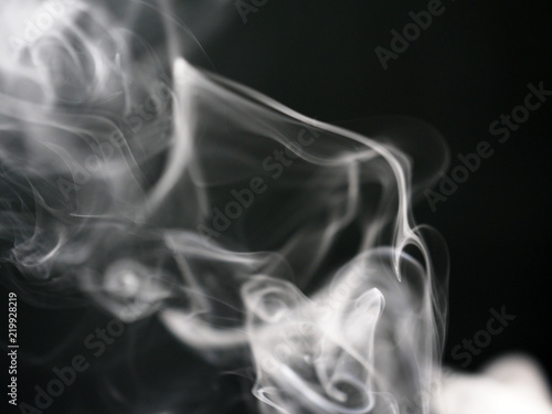 Abstract texture of white smoke isolated on black background