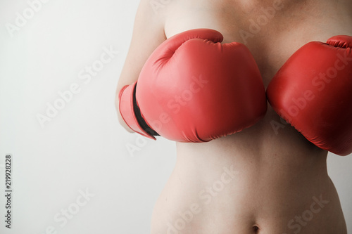 covers the bare breast red boxing gloves. Sexy and strong. Feminism, girl power, fight, gender, woman rights concept
