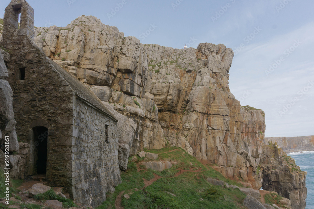 Tiny St Govan's Chapel built on the cliffs of the Pembrokeshire National Park in South Wales