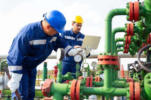 Two workers in the oilfield. Oil and gas concept photo