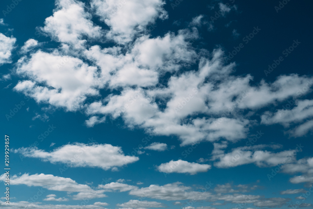 Fototapeta premium Blue sky background with white clouds in summer day, tranquil landscape
