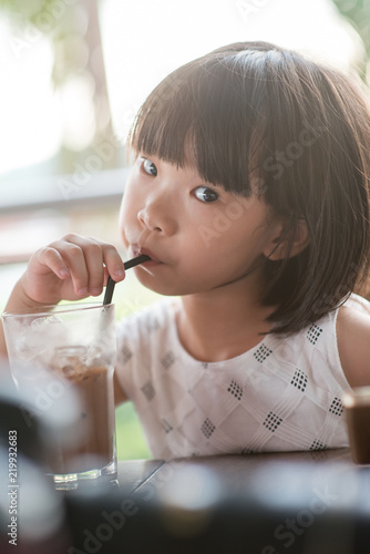 Child drinking at cafe