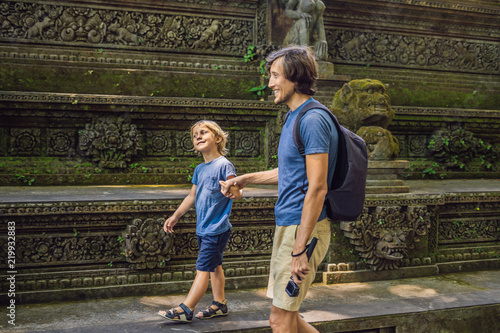 Dad and son travelers discovering Ubud forest in Monkey forest, Bali Indonesia. Traveling with children concept photo