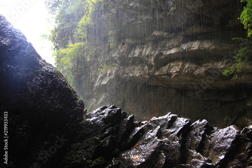 water from the falls falls on the rock and breaks into drops