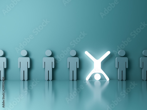 Stand out from the crowd and different creative idea concept One glowing light man standing upside down with arms and legs wide open among other people on dark green background 3D rendering
