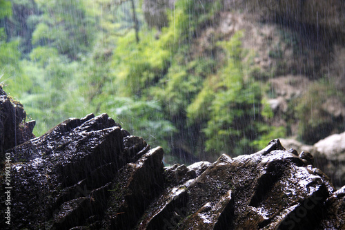 water from the falls falls on the rock and breaks into drops
