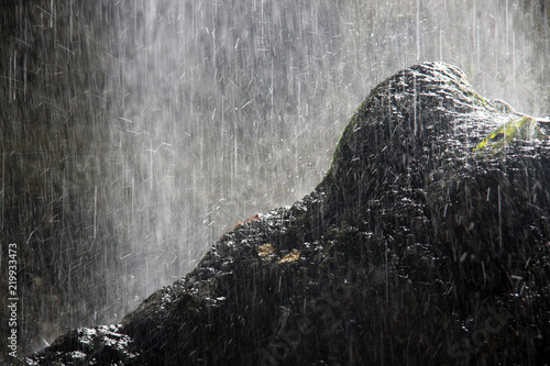 water from the falls falls on the rock and breaks into drops