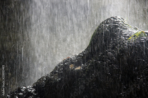 water from the falls falls on the rock and breaks into drops
