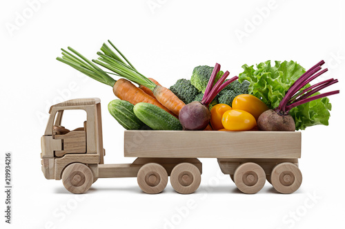 Variety of fresh vegetables in  toy wooden truck.