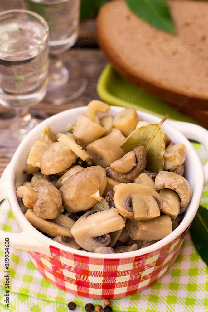 Pickled marinated button mushrooms with pepper and bay leaf Pickled marinated button mushrooms with pepper and bay leaf