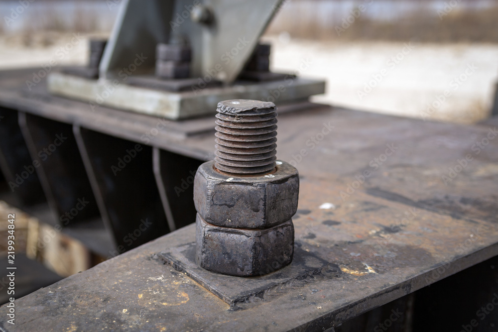 The old nut is screwed to the bolt. Close-up. The old nut is screwed to the bolt. Close-up.