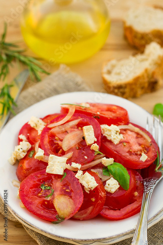 Summer salad with fresh tomatoes, onions and feta cheese