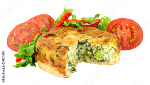 Crustless spinach and kale quiche with fresh salad isolated on a white background