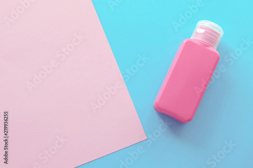 One Pink Bottle On The Pastel Background Light Pink and Blue Colors Mimimal Style Top View Flat Lay