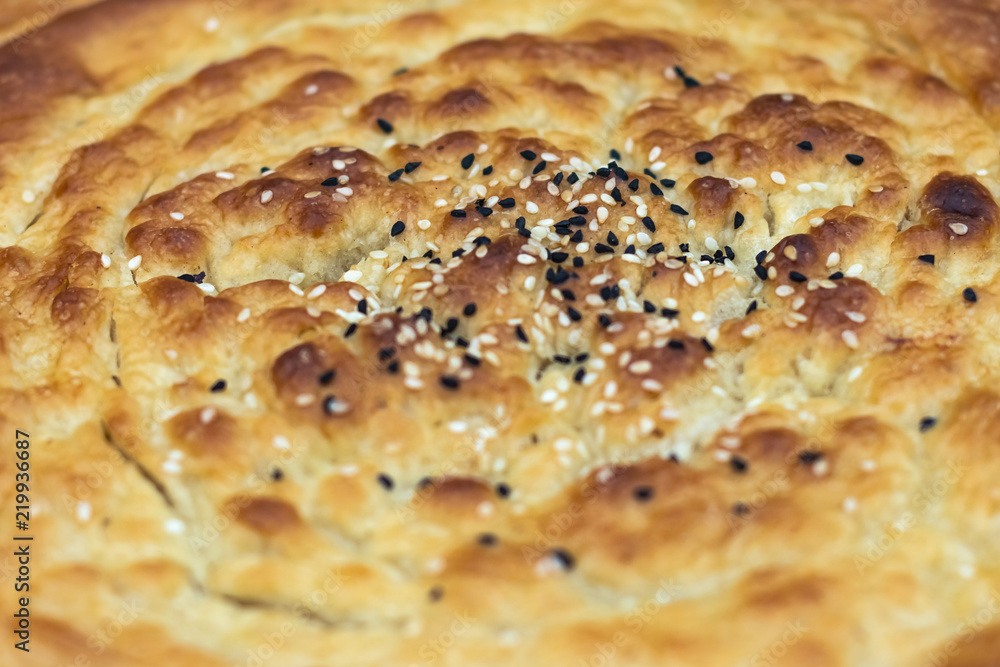 Fresh tandoor cakes baked with seeds. Macro, selective focus. Eastern cuisine. Fresh tandoor cakes baked with seeds. Macro, selective focus. Eastern cuisine.