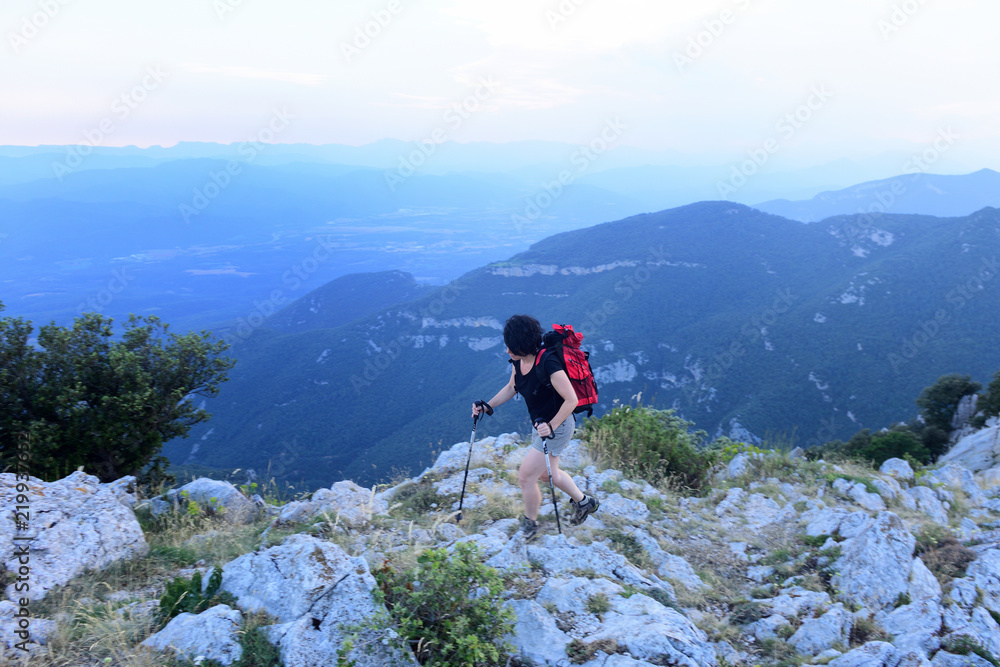 hiking woman walking on the mountain