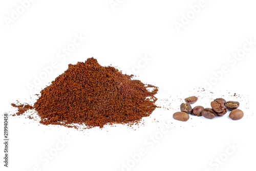 Pile of the ground coffee and few beans isolated on white background