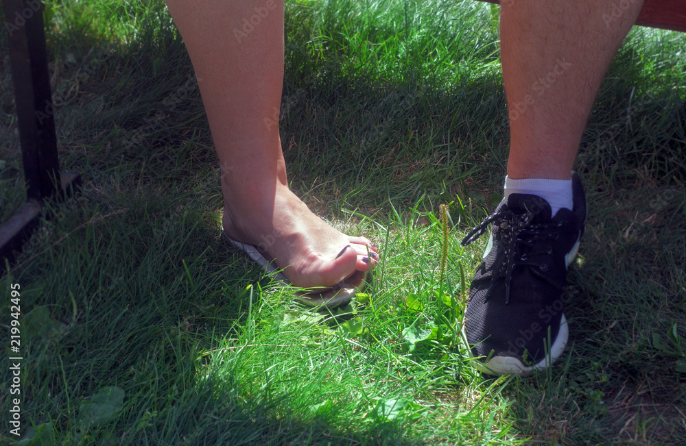 Women's and men's leg on grass