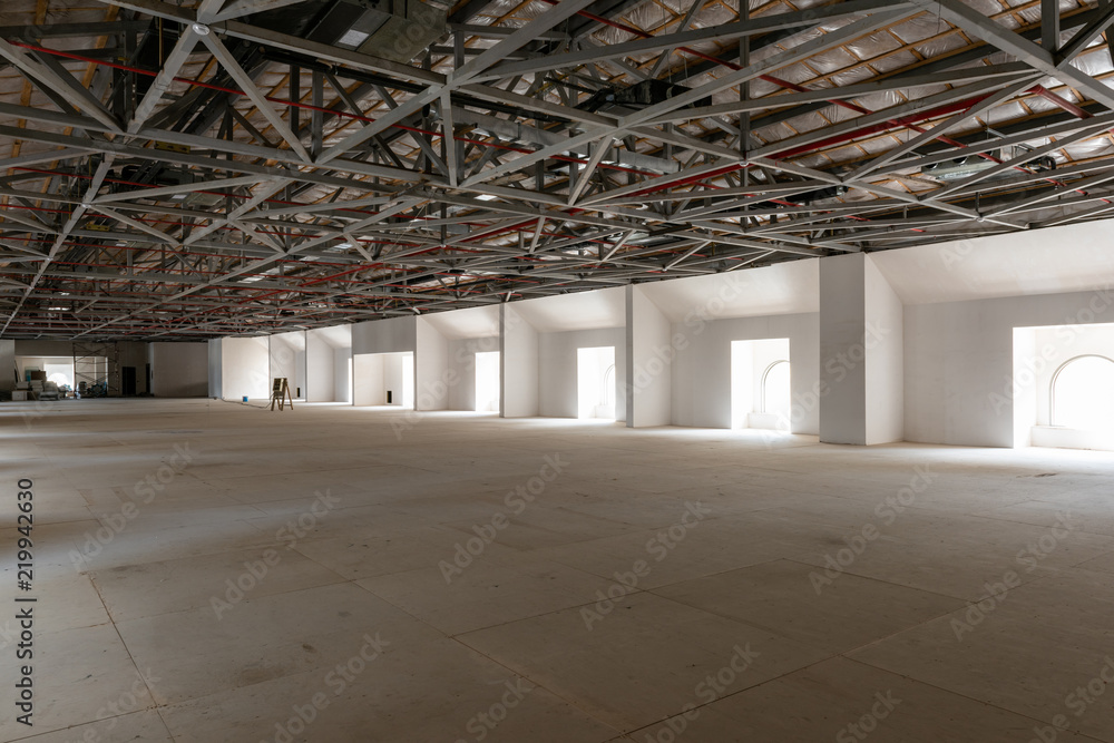 House attic under construction. Interior of large unfinished mansard. House attic under construction. Interior of large unfinished mansard.