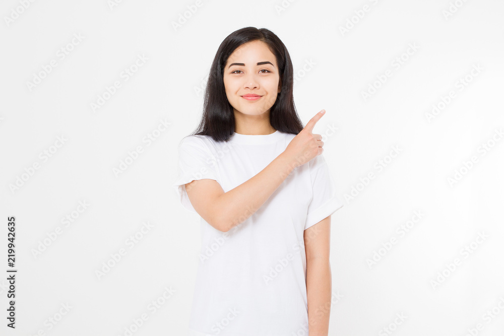 Portrait of smiling young asian woman wearing summer t shirt pointing at copy space by finger isolated on white template and blank background. Portrait of smiling young asian woman wearing summer t shirt pointing at copy space by finger isolated on white template and blank background.