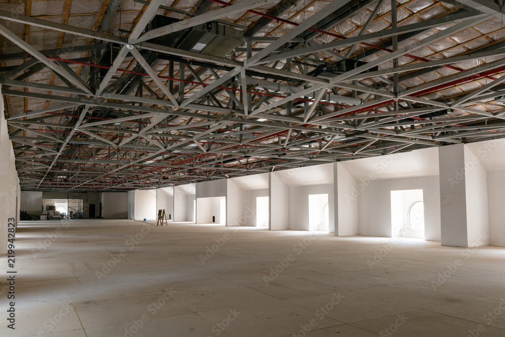House attic under construction. Interior of large unfinished mansard. House attic under construction. Interior of large unfinished mansard.