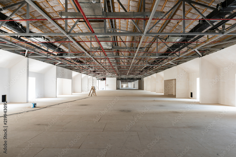 House attic under construction. Interior of large unfinished mansard. House attic under construction. Interior of large unfinished mansard.
