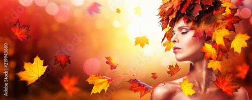 Autumn Beautiful Woman With Falling Leaves Over Nature Background