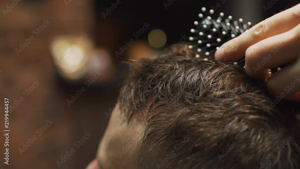 Men's hairstyling, haircutting, in a barber shop or hair salon. Men's hairstyling, haircutting, in a barber shop or hair salon.