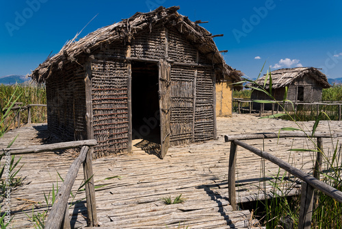 Huts at the reconstructed site of a prehistoric settlement at the Kastoria Lake in Dispilio, Greece  photo