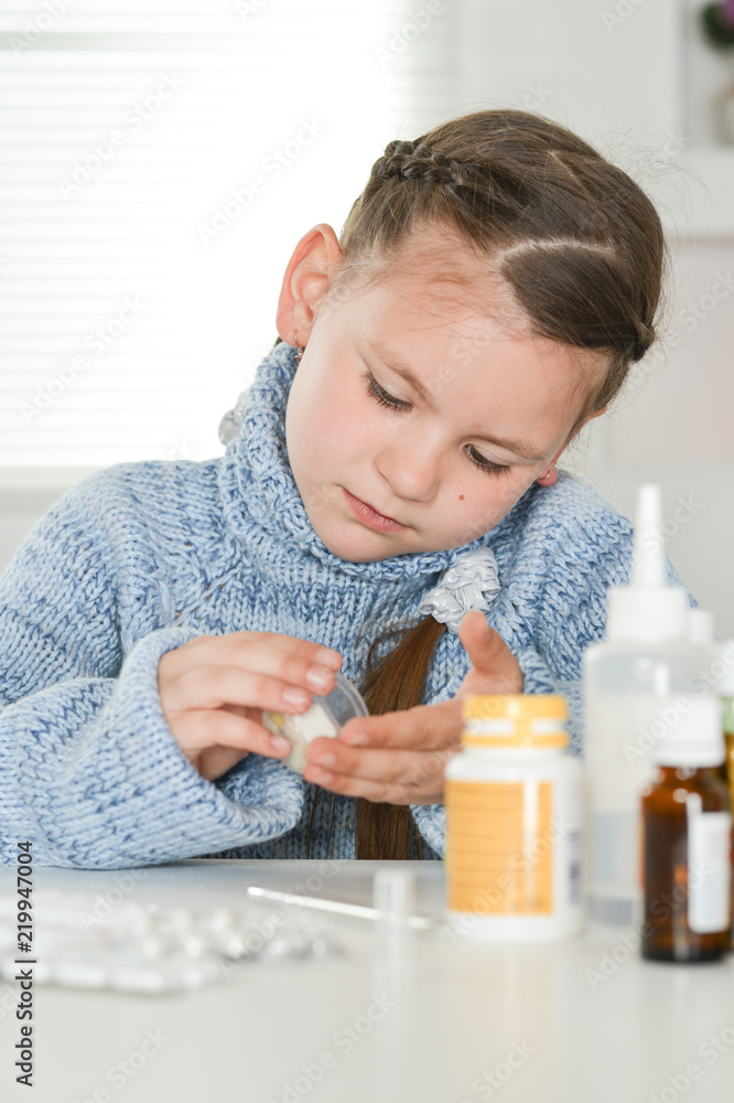 Close up portrait of young sick girl taking medicines Close up portrait of young sick girl taking medicines