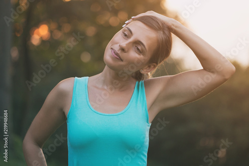 Beautiful woman enjoys exercising in the nature.