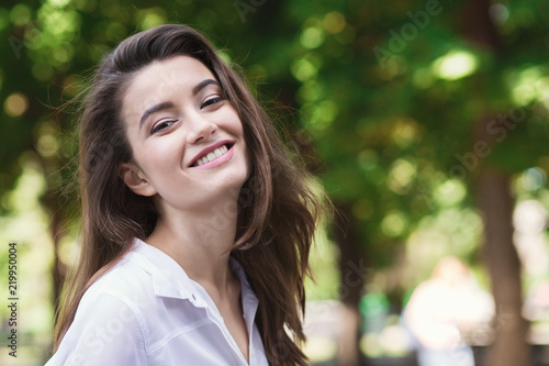 Portrait of happy young woman walking outdoors